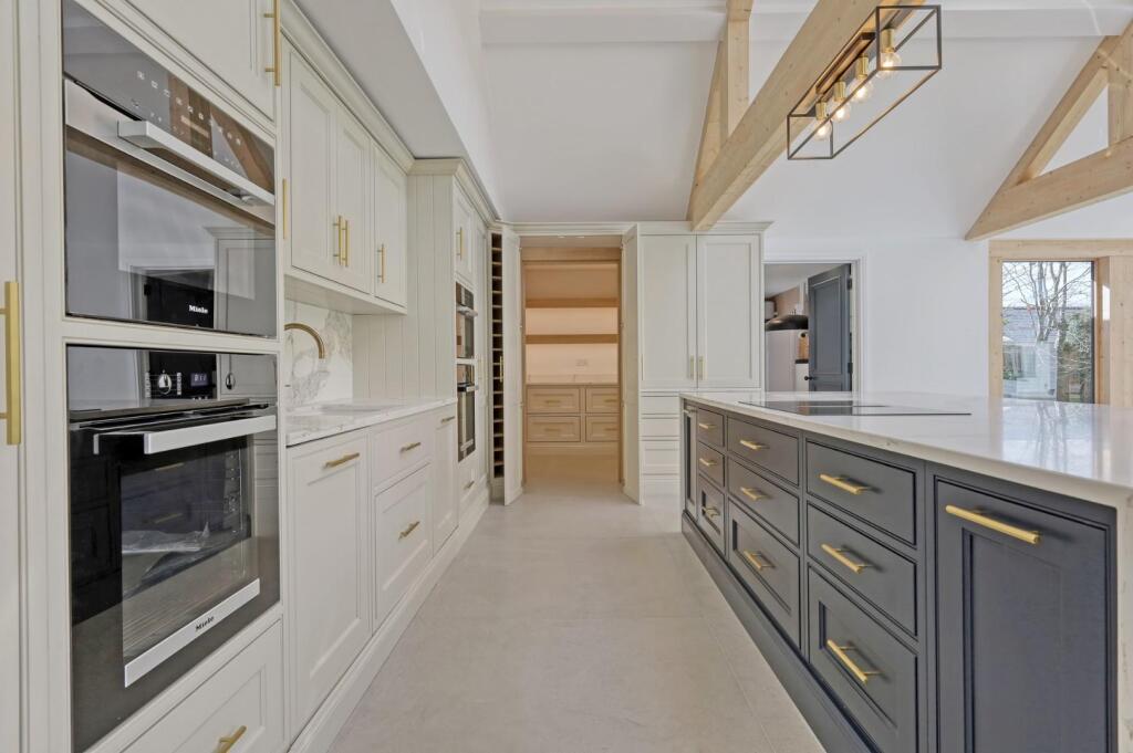 Kitchen appliance wall, island drawers and entrance to the pantry