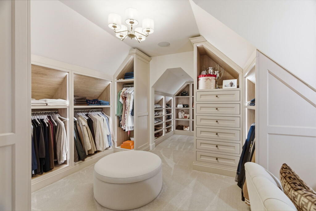Bespoke walk-in dressing room fitted around sloping ceilings
