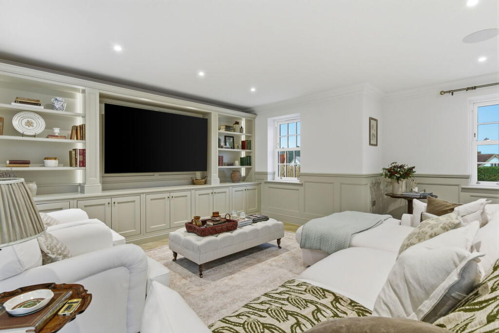 Bespoke painted media wall with library shelving and concealed storage